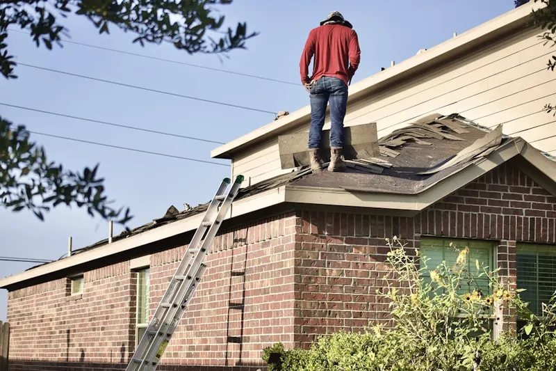 Professional roofer working on a residential roof in Dobbins Creek